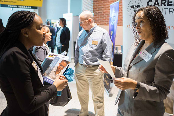 Student talking with recruiter at career fair