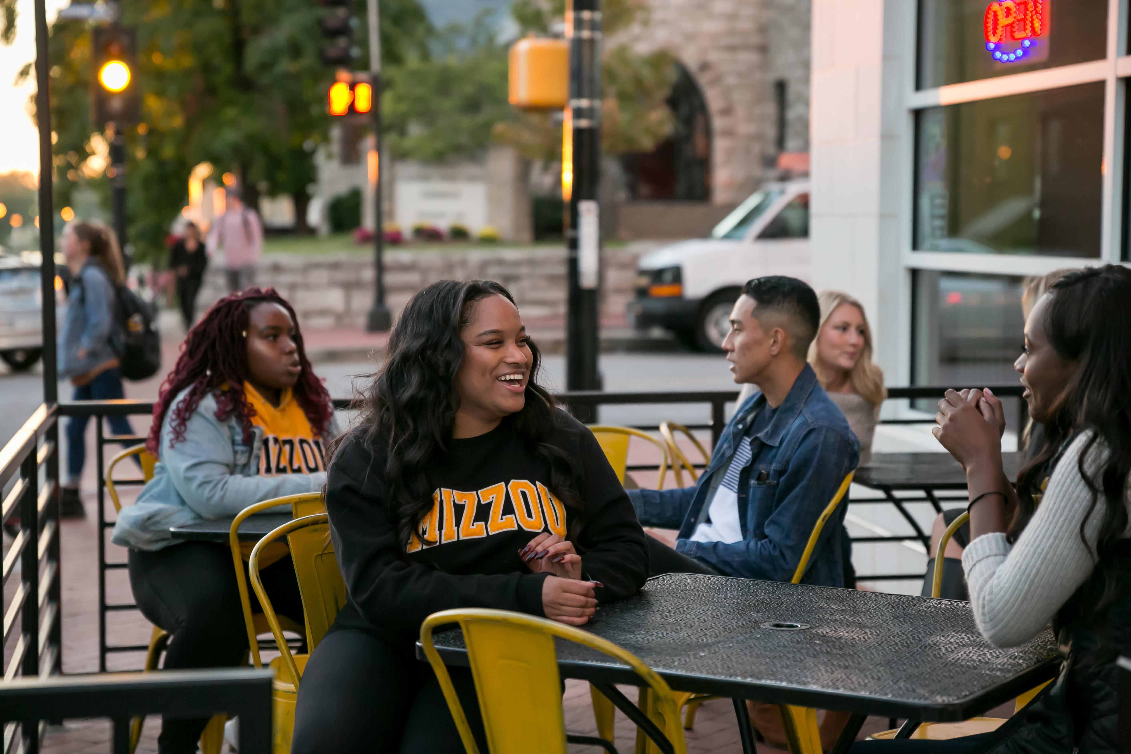 Students sitting at outdoor tables in downtown Columbia