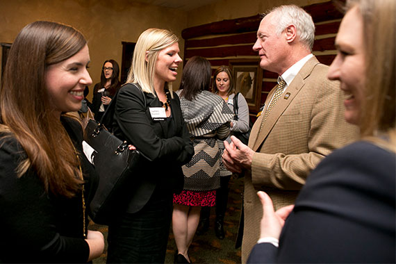 Students networking with alumni at mixer